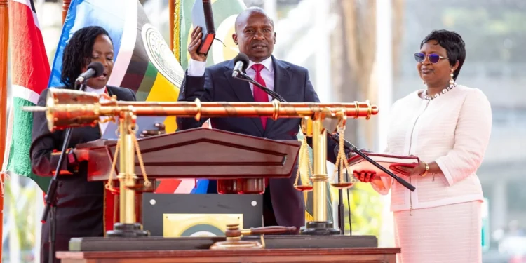 Chief Registrar of the Judiciary, Hon. Winfridah Bokaya, leads Kithure Kindiki in the oath-taking process as the Deputy President of the Republic of Kenya, alongside his wife, Dr. Joyce Kithure, at Kenya's iconic Kenyatta International Convention Center (KICC), Nairobi.